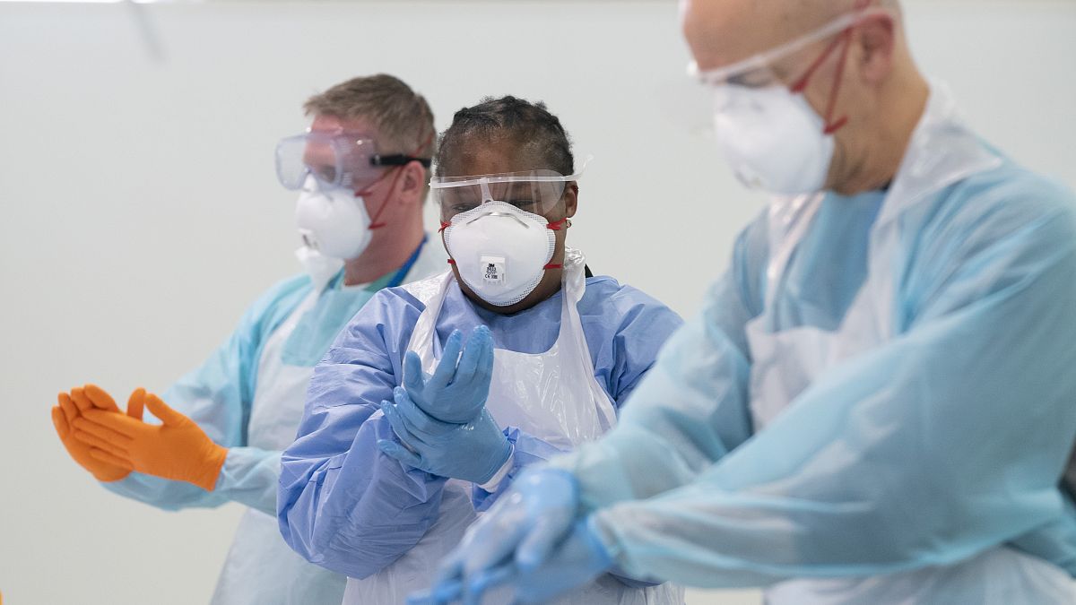 Staff receive training on how to put on and remove PPE, personal protective equipment against the coronavirus, Nightingale Hospital North West, Manchester, UK, April 16, 2020 