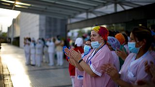 Health workers applaud medical staff working at the Puerta de Hierro hospital in Majadahonda, Spain, Saturday, April 18, 2020 
