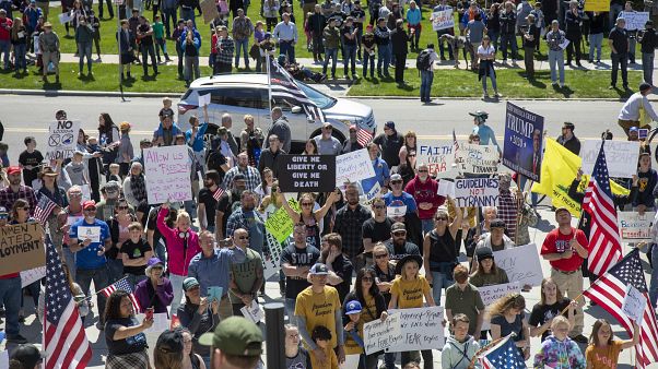 Several hundred people attend a "Stand for Freedom" rally against - and in violation of - a stay-at-home locidown order in Boise, Idaho, Friday, April 17, 2020. 