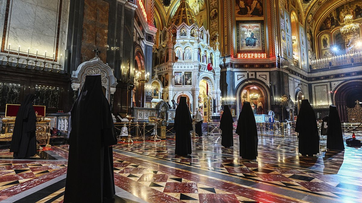 Russian Orthodox Church nuns, observe social distancing guidelines as they attend an Orthodox Easter service at Moscow's Christ the Saviour Cathedral, Sunday, April 19, 2020