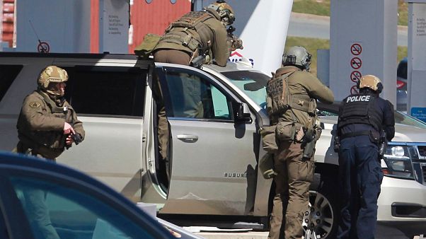 Royal Canadian Mounted Police officers surround a suspect at a gas station in Enfield, Nova Scotia, April 19, 2020 Royal Canadian Mounted Police officers surround a suspect at a gas station in Enfield, Nova Scotia, April 19, 2020