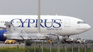 A Qatar Air Force fighter jets on the ground next of a Cyprus airways Airbus A330