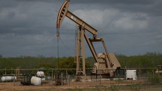 In this file photo taken on March 12, 2019 a pump jack operates at an oil extraction site in Cotulla, Texas