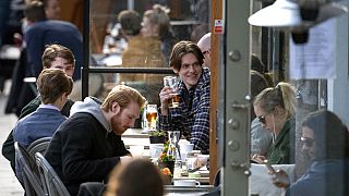 People enjoy themselves at an outdoor restaurant, amid the coronavirus outbreak, in central Stockholm, Sweden