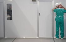 A member of staff dons his factory-made PPE at a hospital in Manchester