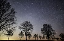 The starry sky shines in the night over an avenue in Petersdorf, eastern Germany, Monday, April 20, 2020.