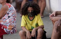 Uma criança protege-se da Covid-19 na favela Mandela, Rio de Janeiro