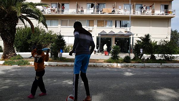 Migrant boys play with a ball outside a hotel in Kranidi town, about 170 kilometers southwest of Athens, Tuesday, April 21, 2020 Migrant boys play with a ball outside a hotel in Kranidi town, about 170 kilometers southwest of Athens, Tuesday, April 21, 2020
