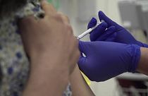 Screen grab taken from video issued by Britain's Oxford University, showing a person being injected as part of the first human trials in the UK to test a potential coronavirus