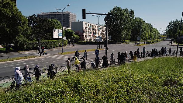 Residents line up to collect food, soap and other staples distributed by volunteers in Clichy-sous-Bois, France on Wednesday, April 22, 2020 Residents line up to collect food, soap and other staples distributed by volunteers in Clichy-sous-Bois, France on Wednesday, April 22, 2020