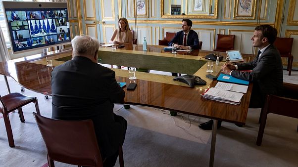French President Emmanuel Macron (R) attends the video conference French President Emmanuel Macron (R) attends the video conference