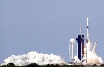 A Falcon 9 rocket with approximately 60 satellites for SpaceX's Starlink broadband network, lifts off from Kennedy Space Center in Cape Canaveral