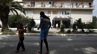 Migrant boys play with a ball outside a hotel in Kranidi town about 170 kilometers (106 miles) southwest of Athens, Tuesday, April 21, 2020