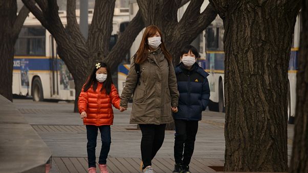A family wear face masks in Seoul A family wear face masks in Seoul