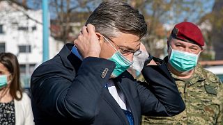 Croatia's Prime Minister Andrej Plenkovic puts on a protective mask on a visit to a hospital area in Zagreb for treatment of possible COVID-19 patients. March 20, 2020 