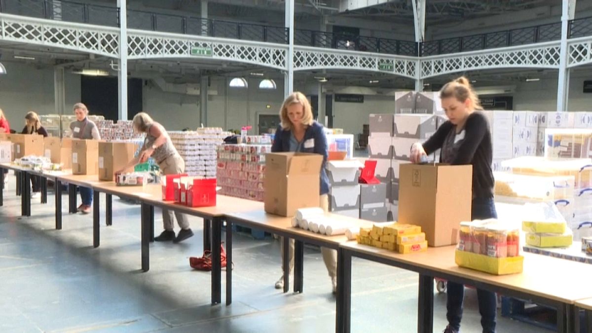 Volunteers putting food into boxes at London Olympia