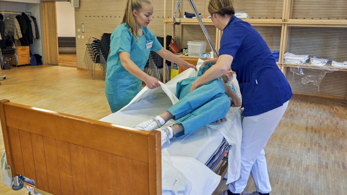 Former Scandinavian Airlines flight attendants learn basic skills on to assist in nursing homes and hospitals, Stockholm, Wednesday, April 1, 2020.