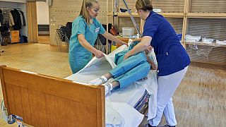 Former Scandinavian Airlines flight attendants learn basic skills on to assist in nursing homes and hospitals, Stockholm, Wednesday, April 1, 2020.