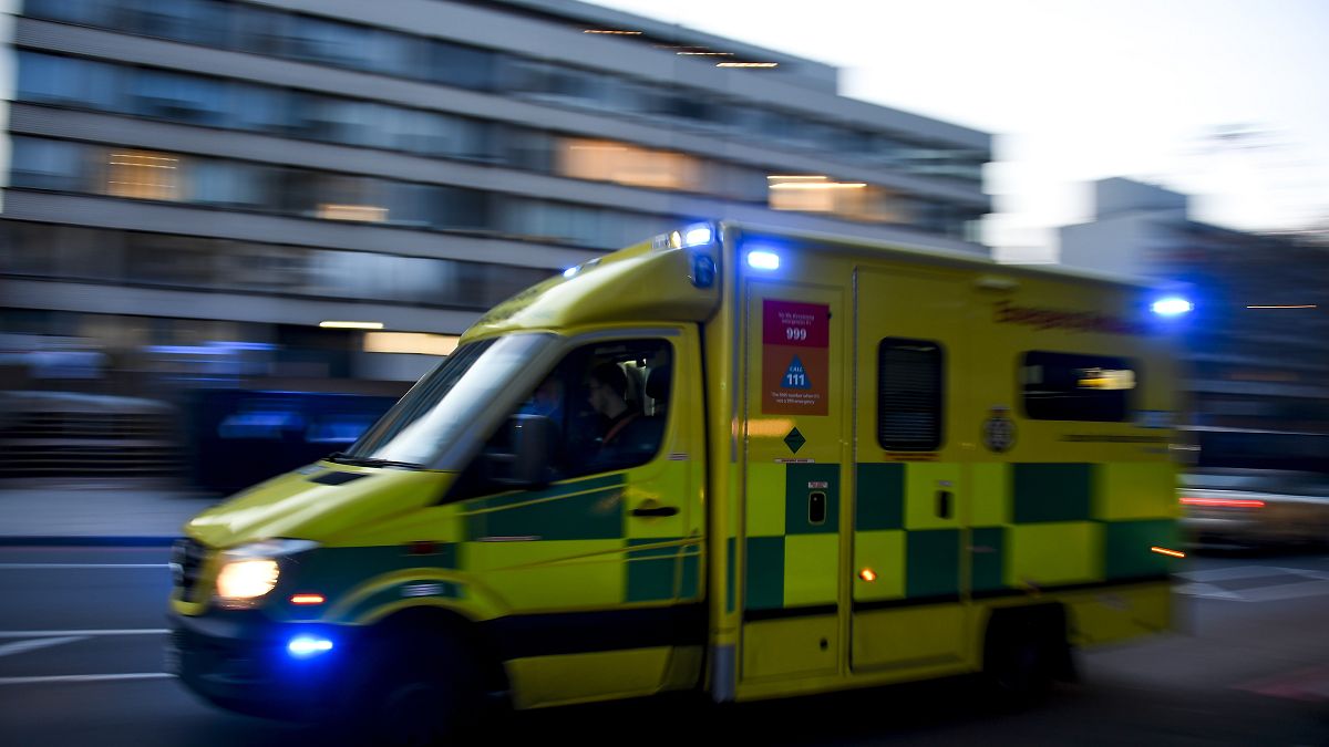 An ambulance drives past St Thomas' Hospital in central London on April 7, 2020.