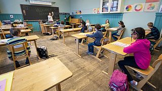 Third grade pupils at Nordstrand Steinerskole school in Oslo attend a lesson after the school reopened on April 27, 2020