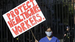 An NHS doctor protests in front of Downing Street on April 19, 2020