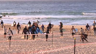 Coronavirus: Swimmers and surfers return to Sydney's Bondi Beach after COVID-19 lockdown