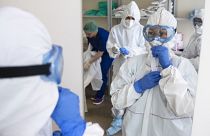 Medical workers put on protective gear in order to assist coronavirus patients at the intensive care unit of Vinogradov City Clinical Hospital in Moscow, Russia. 