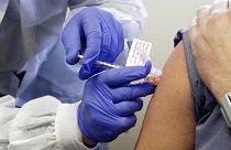 a patient receives a shot in the first-stage safety study clinical trial of a potential vaccine for COVID-19 in  in Seattle, US, on March 26, 2020.