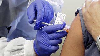 a patient receives a shot in the first-stage safety study clinical trial of a potential vaccine for COVID-19 in  in Seattle, US, on March 26, 2020.