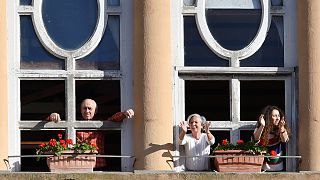 March 3, 2020. People applaud from their window in Rome to celebrate the easing of the lockdown restrictions scheduled for the following day.