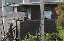 Army soldiers walk up the stairs of their military guard post in Paju, South Korea