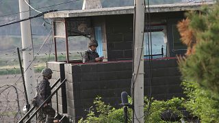 Army soldiers walk up the stairs of their military guard post in Paju, South Korea