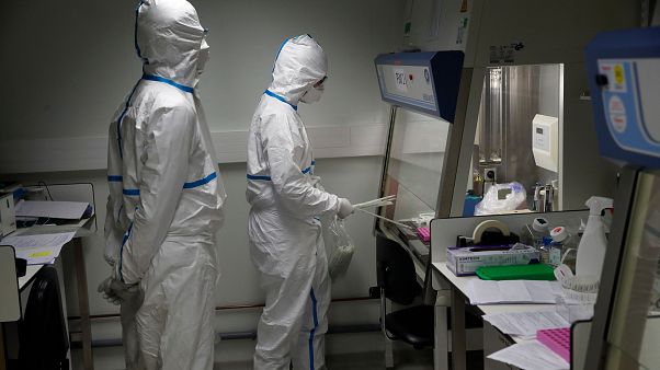 French lab scientists in hazmat gear test patient samples at Pasteur Institute in Paris French lab scientists in hazmat gear test patient samples at Pasteur Institute in Paris