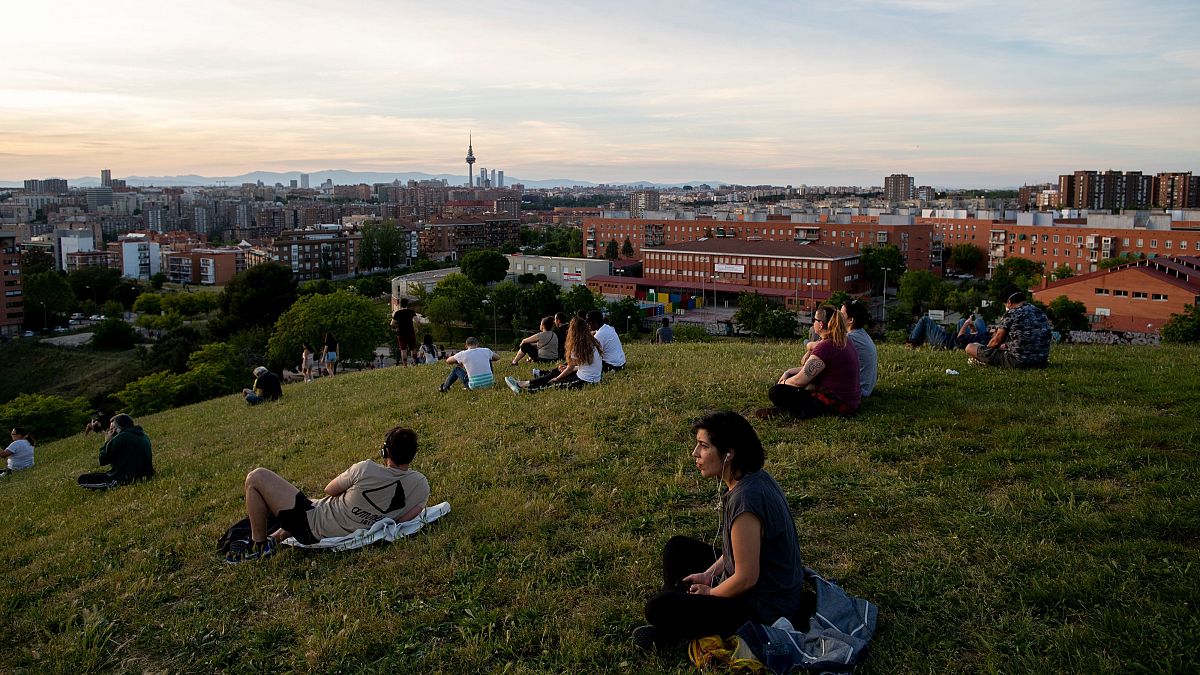 People sit in the Cerro del Tio Pio park in Madrid, Spain, after the lockdown was eased on the weekend