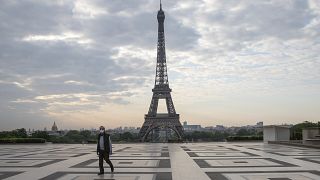 A man wears a mask to protect against the spread of the coronavirus as he walks along the Trocadero square close to the Eiffel Tower in Paris