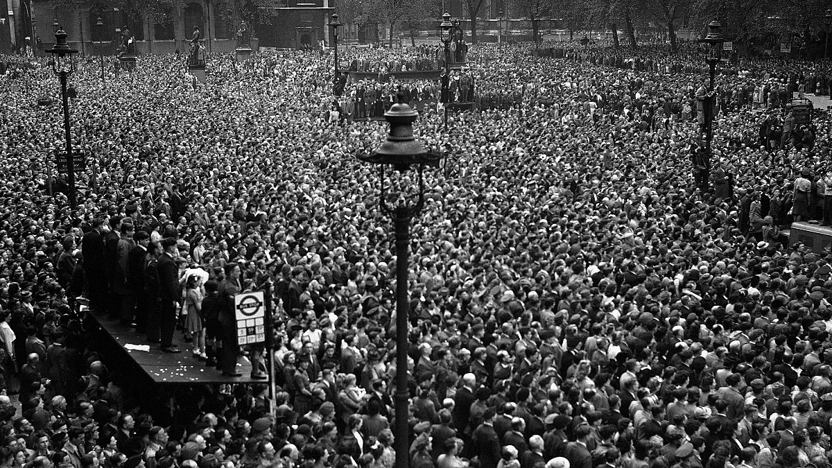 Huge crowds cram into Whitehall and Parliament Square, central London, to hear Prime Minister Winston Churchill announce the end of the war in Europe. May 8, 1945.