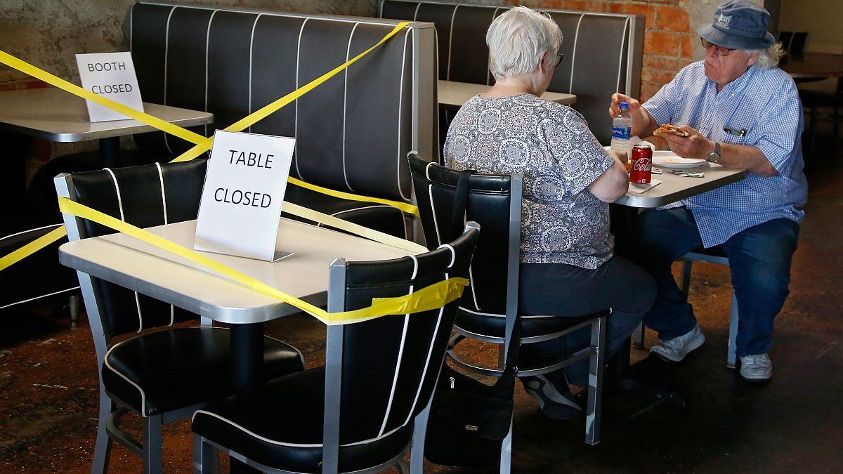 Tables are taped off to promote social distancing at Falcone's Pizzeria in Oklahoma City, as restaurants are allowed to open for in person dining