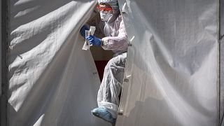A medical staff gets out from a tent of a testing point for the COVID-19 coronavirus in central Moscow