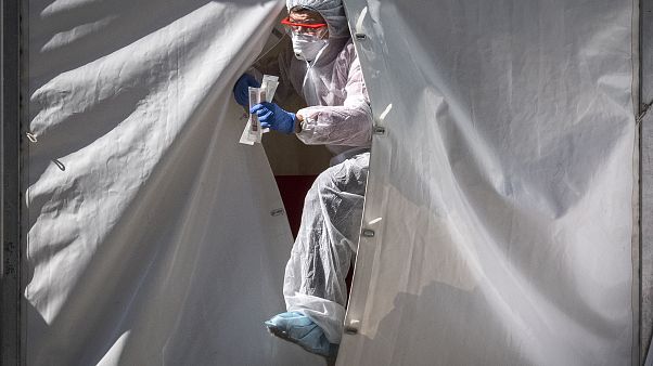 A medical staff gets out from a tent of a testing point for the COVID-19 coronavirus in central Moscow A medical staff gets out from a tent of a testing point for the COVID-19 coronavirus in central Moscow