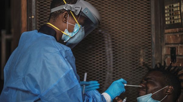 A Gauteng Health Department Official collects samples from a man A Gauteng Health Department Official collects samples from a man