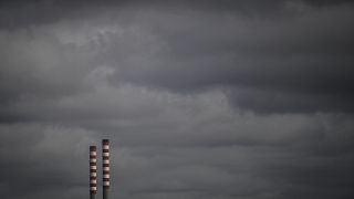 Industrial chimneys are pictured at Sines port on February 12, 2020 in Sines. (Photo by PATRICIA DE MELO MOREIRA / AFP)