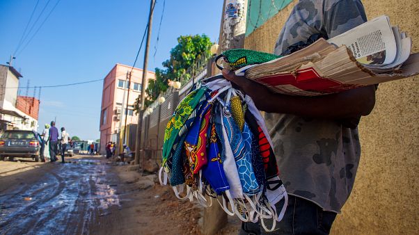 A street vendor sells material masks as a preventive measure against the spread of the COVID-19 A street vendor sells material masks as a preventive measure against the spread of the COVID-19