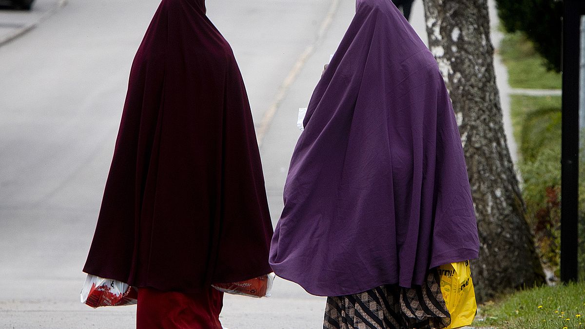 Two women Walk through the town of Flen, some 100 km west of Stockholm in 2018.