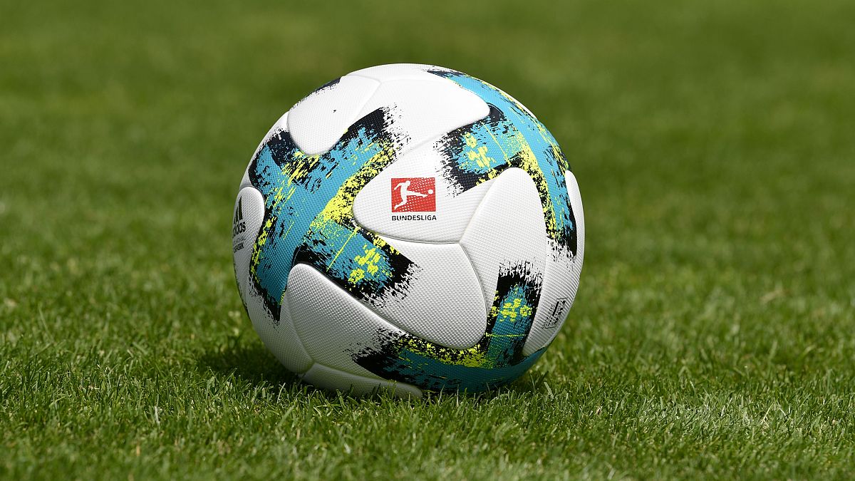 In this file photo taken on August 01, 2017 a ball with the logo of the German first division football league Bundesliga is seen on the pitch