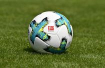 In this file photo taken on August 01, 2017 a ball with the logo of the German first division football league Bundesliga is seen on the pitch