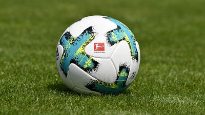 In this file photo taken on August 01, 2017 a ball with the logo of the German first division football league Bundesliga is seen on the pitch