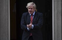 Britain's Prime Minister Boris Johnson joins in the applause on the doorstep of 10 Downing Street in London during the weekly "Clap for our Carers" Thursday, May 7, 2020.