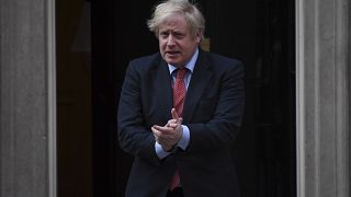 Britain's Prime Minister Boris Johnson joins in the applause on the doorstep of 10 Downing Street in London during the weekly "Clap for our Carers" Thursday, May 7, 2020.