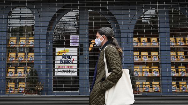A woman walks by the closed "Books Are Magic" bookstore on May 5, 2020 in the Brooklyn borough of New York City. (Photo by Angela Weiss / AFP) A woman walks by the closed "Books Are Magic" bookstore on May 5, 2020 in the Brooklyn borough of New York City. (Photo by Angela Weiss / AFP)