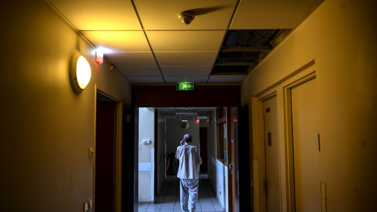 A patient walks in a corridor of the  Clos Benard psychiatric hospital in Aubervilliers,